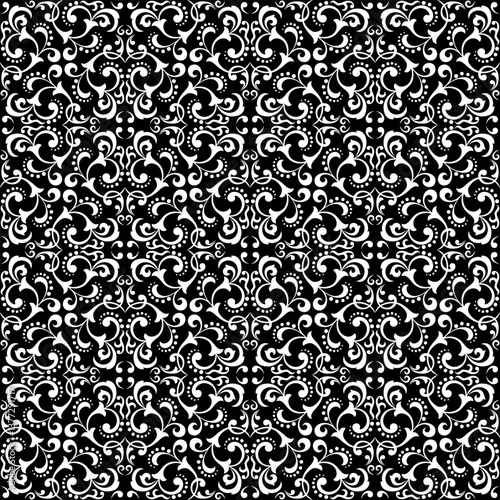 Wallpaper in the style of Baroque. White and black floral ornament. Seamless vector background. Graphic pattern for fabric, wallpaper, packaging. Ornate Damask flower illustration.