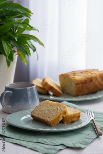 Two pieces of fresh cake on a plate.