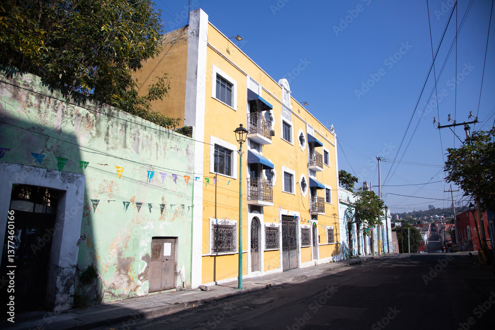 Fototapeta premium Puebla, Mexico, 1st January 2025: Colored streets and colonial buildings of the city and Mexican capital of Puebla.