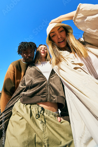 Friends posing together outdoors in casual fashion on a sunny da