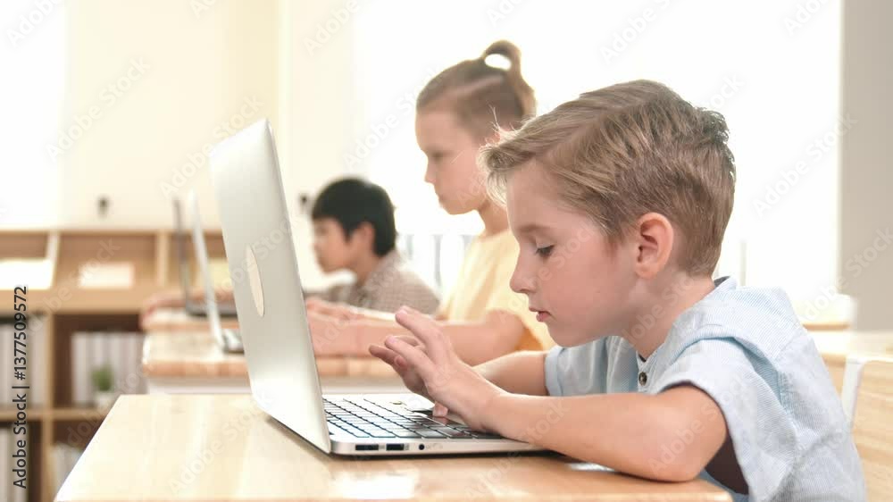 Caucasian smart child programing software system and learning about coding while multicultural searching about engineering code. Happy boy thinking about engineering prompt by using laptop. Pedagogy. Caucasian smart child programing software system and learning about coding while multicultural searching about engineering code. Happy boy thinking about engineering prompt by using laptop. Pedagogy.