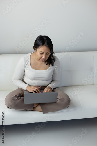 Vertical image of woman working on laptop photo