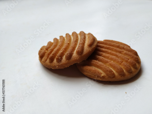 Round Whole Brown Color Biscuit and Cut Cookie isolated on white Background. Curve Shape pattern above the biscuit.