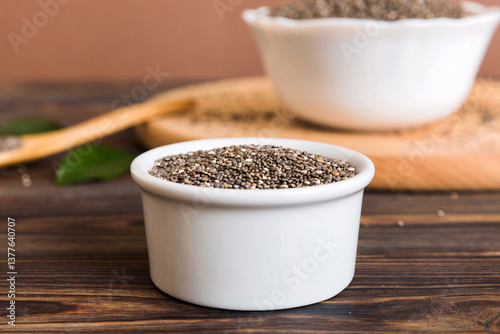 Bild auf Leinwand Chia seeds in bowl and spoon on colored background