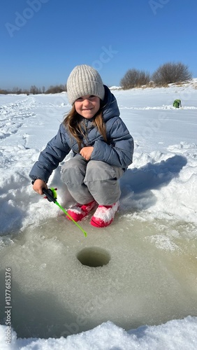 little girl playing in snow. winter fishing. winter fun