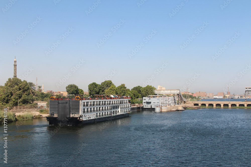 Fototapeta premium View of cruise ships queuing to pass through the Esna Lock on the River Nile, Egypt