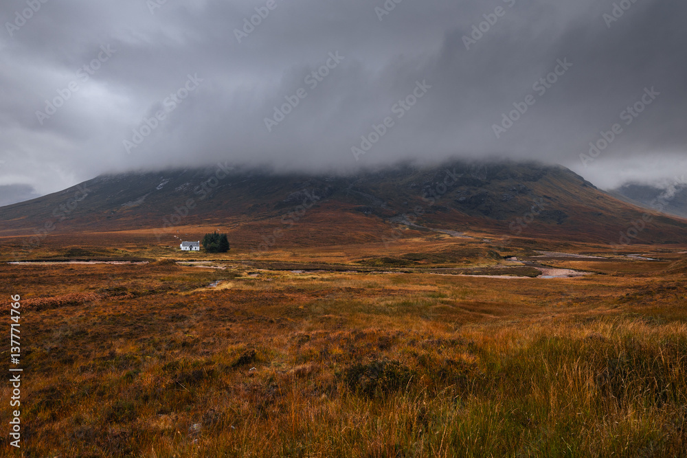 Dramatic peaks and misty valleys define Glen Coe, Scotland’s iconic Highland landscape. Golden light dances on rugged slopes, creating a scene of wild, untamed beauty.