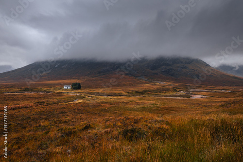 Obraz na płótnie Dramatic peaks and misty valleys define Glen Coe, Scotland’s iconic Highland landscape. Golden light dances on rugged slopes, creating a scene of wild, untamed beauty. w salonie