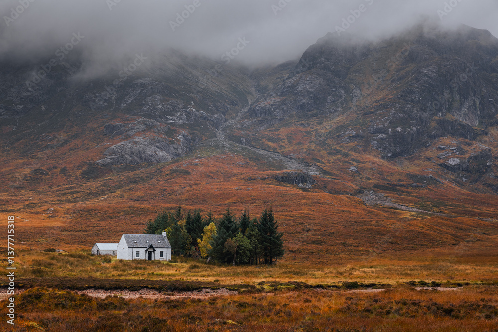 Dramatic peaks and misty valleys define Glen Coe, Scotland’s iconic Highland landscape. Golden light dances on rugged slopes, creating a scene of wild, untamed beauty.