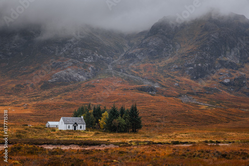 Obraz na płótnie Dramatic peaks and misty valleys define Glen Coe, Scotland’s iconic Highland landscape. Golden light dances on rugged slopes, creating a scene of wild, untamed beauty. w salonie
