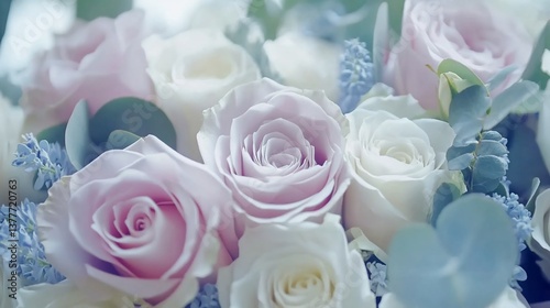 Pastel pink and white roses with eucalyptus leaves in a bouquet