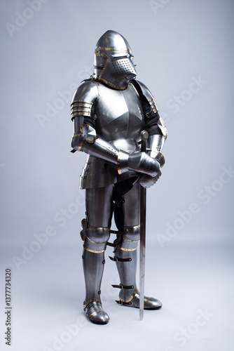 Full Suit of Fourteenth Century Knight's Plate Armor. Impressive display of medieval protective gear, including helmet, breastplate, gauntlets, and greaves