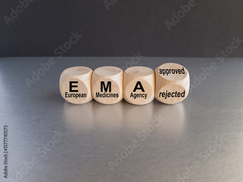 Cubes form the expression EMA (European Medicines Agency) approved or rejected. Beautiful black background, gray table. Medical concept.