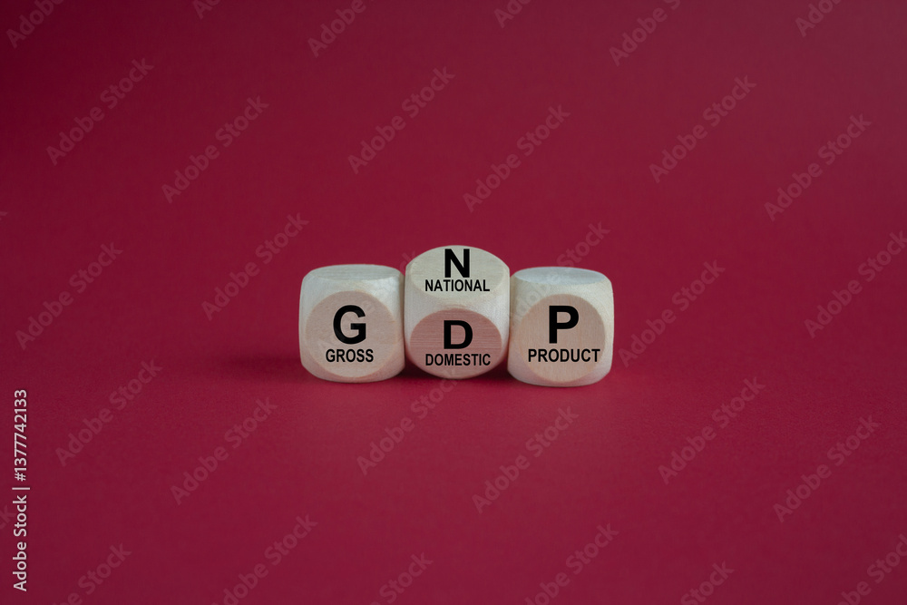 Dices form the expressions GDP (gross domestic product) and GNP (gross national product). Beautiful red background. Business concept.