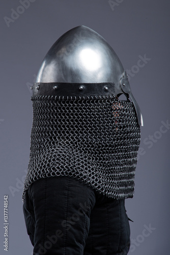 Norman Helmet with Chainmail Aventail. Medieval head protection with nasal bar and attached chainmail neck guard. photo