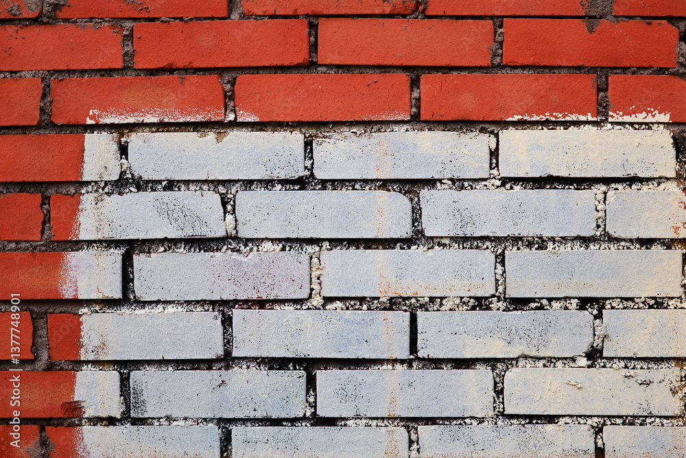 A red and white brick wall with a white line painted on it.