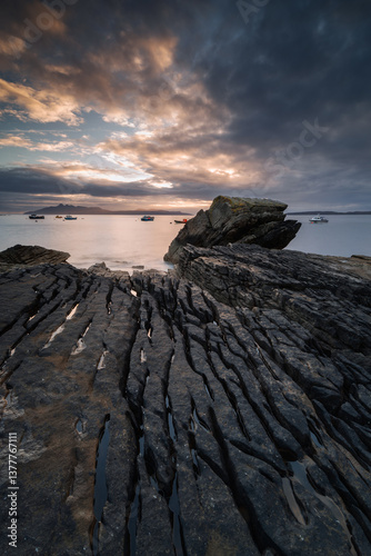 Obraz na płótnie Dramatic waves crash against Elgol’s rugged coast, with the Cuillin Mountains rising in the misty distance. Autumn’s golden light enhances this wild, untamed beauty. w salonie