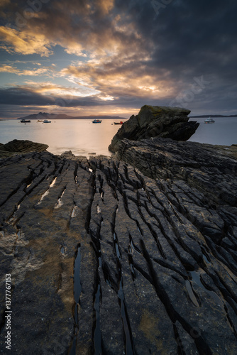Obraz na płótnie Dramatic waves crash against Elgol’s rugged coast, with the Cuillin Mountains rising in the misty distance. Autumn’s golden light enhances this wild, untamed beauty. w salonie