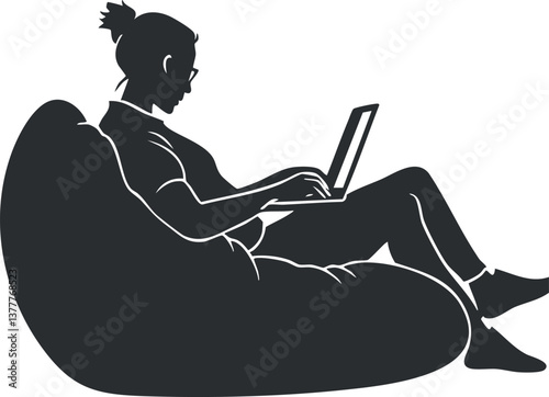 Silhouette of a woman working on a laptop while sitting on a beanbag chair.