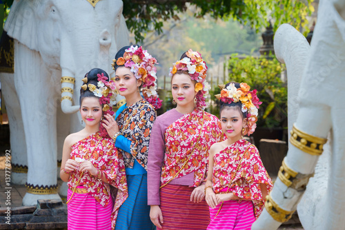 Beautiful traditional Thai dress, Lanna. Pretty Asian women wearing ancient native Northern Thai dress costumes according Thai culture and tradition at the ancient temple of Chiang Mai, Thailand. photo