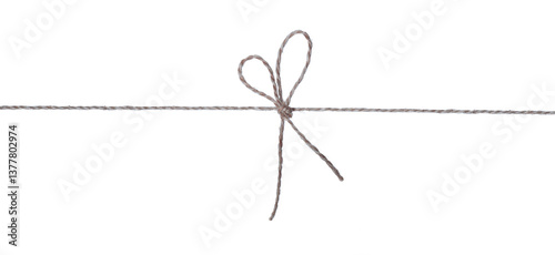 A bow tied in the center of the thread in the form of a heart is isolated on white.  photo