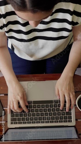 Professional woman typing on laptop, showcasing concentrated workflow with dynamic keyboard perspectives, representing modern digital workplace efficiency