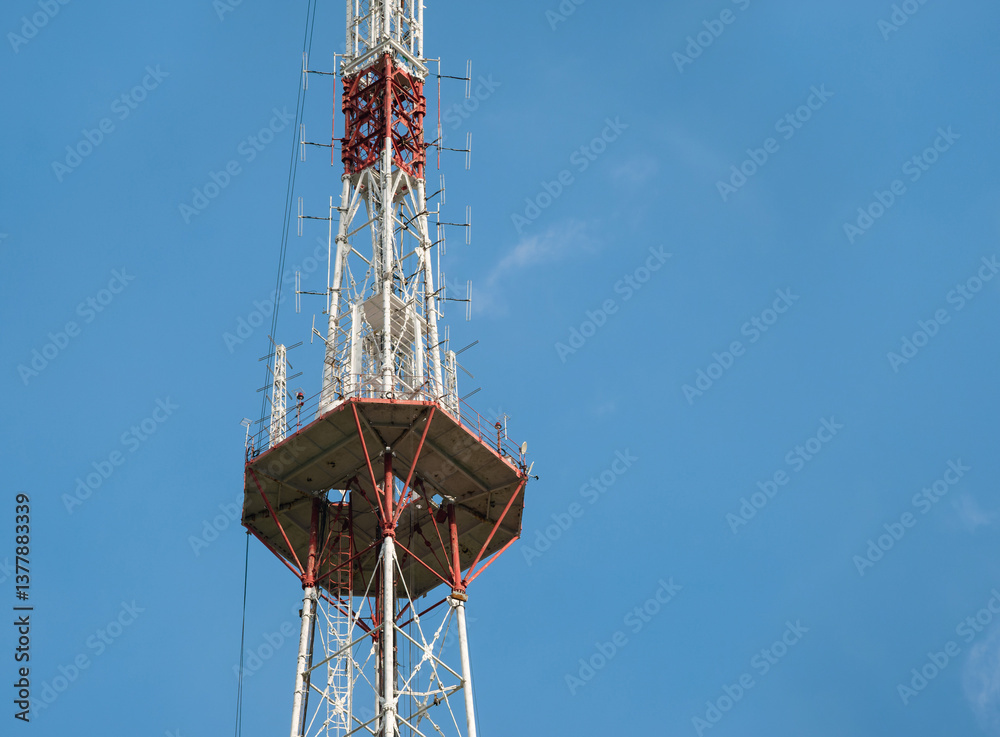One of the upper tiers of a tall metal television broadcasting tower One of the upper tiers of a tall metal television broadcasting tower