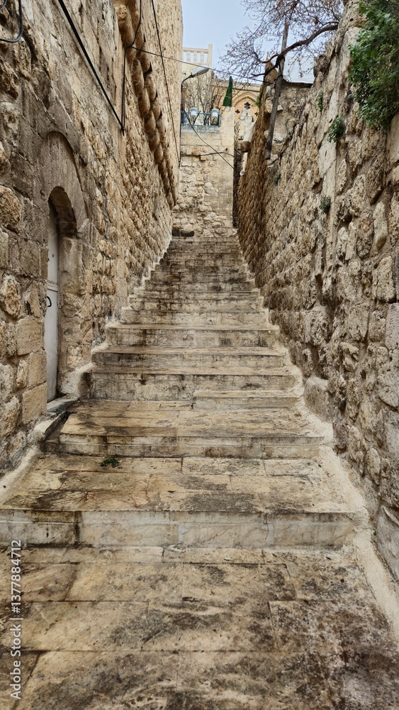 Fototapeta premium stone paved stairs between old Mardin stone houses