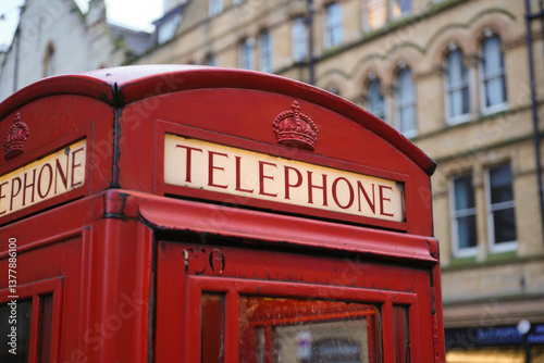 Iconic red british telephone booth in urban street setting