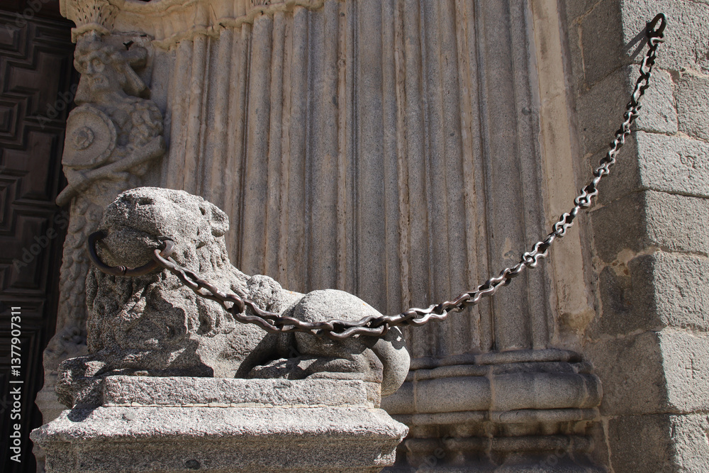 sculpted lion in front of the cathedral in avila in spain