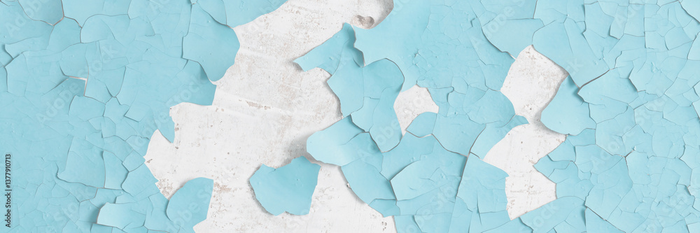 Peeling paint on the wall. Old concrete wall with cracked flaking paint. Weathered rough painted surface with patterns of cracks and peeling. High resolution texture for background and design. Closeup