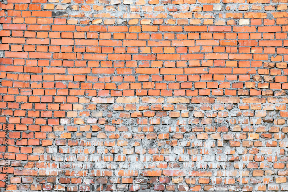 Rustic brick wall showcasing aged texture and vibrant color variations under sunlight