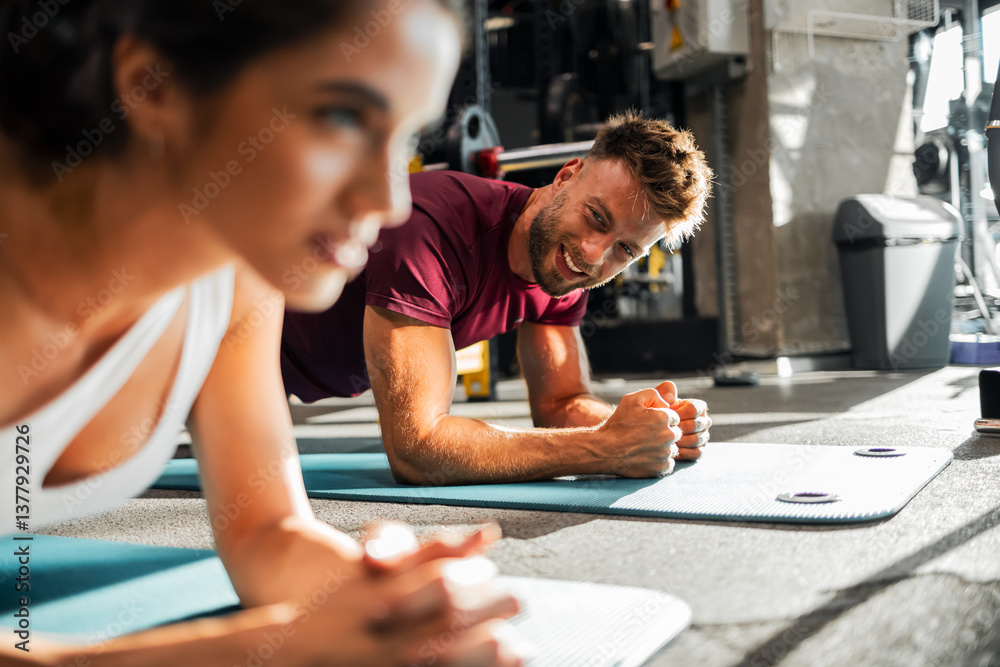 Couple Performing Planks Together in a Gym Setting
