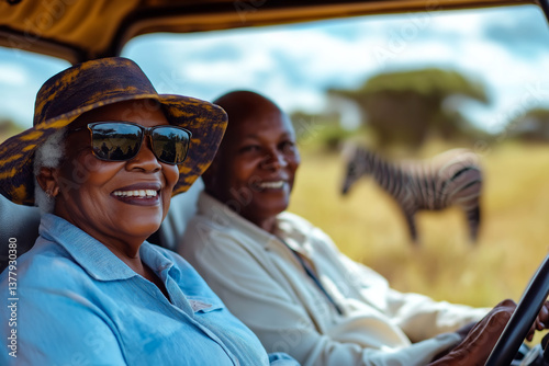 Elderly couple enjoying safari experience with zebra in the background in wilderness