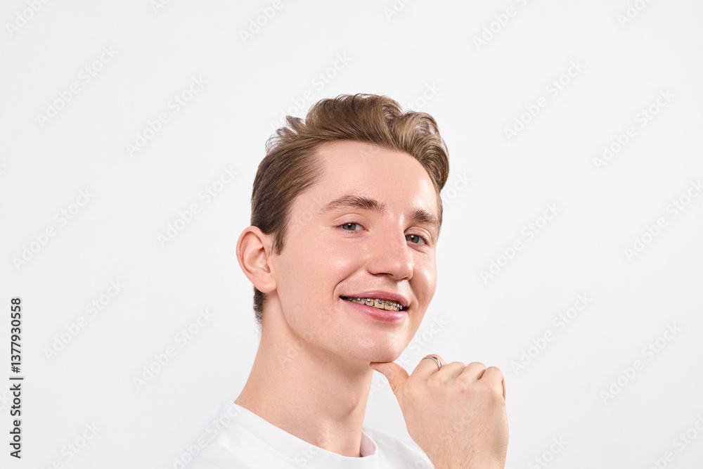 A man with a beaming smile stands out in a crowd, his joyful expression catching the eye of onlookers. His face radiates happiness, his grin infectious and genuine