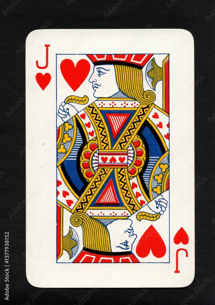 Obraz premium A vintage playing card in the suit of hearts isolated on a black background.