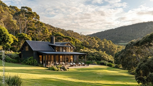 A luxurious wooden country house with Nordic architecture nestled near Wilson's  Promontory, surrounded by lush greenery and rolling hills.
