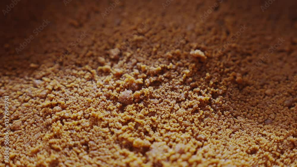 A close up of a brown substance with a grainy texture. The substance appears to be a type of flour or sand A close up of a brown substance with a grainy texture. The substance appears to be a type of flour or sand