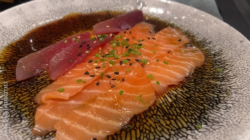 Close-up of Salmon and Tuna Carpaccio with Marinade at Restaurant