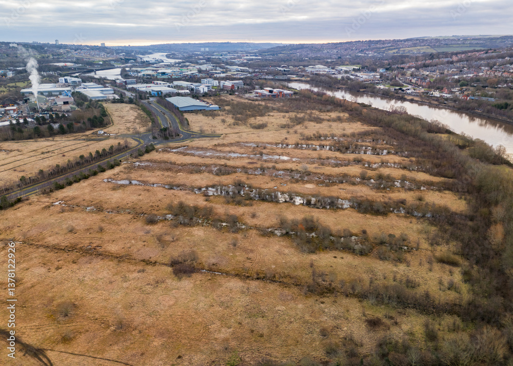 Industrial park development with loads of empty land and flooded water logged fields