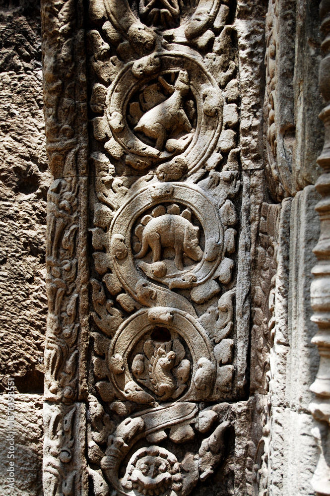 Fototapeta premium Sculpture carving story khmer Empire on wall in Prasat Ta Prohm or Ancestor Brahma temple of Angkor Thom Wat for cambodian people foreign travelers travel visit at Siemreap city in Siem Reap, Cambodia