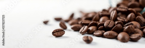 Dark brown coffee beans scattered on white surface, blurred motion, coffee beans falling, coffee product advertising