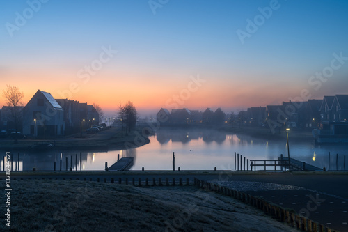 Obraz na płótnie A tranquil, foggy dawn in a suburb at the waterfront in the Netherland. Meerstad. w salonie