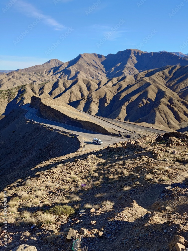 Scenic Mountain Road with Vehicle and Travelers, Tizi n Tichka in Morocco