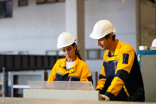 Unity and teamwork concept. Two professional engineer worker working control sheet metal roof tile roll forming machine at metal sheet profiling factory. Industrial production. Teamwork