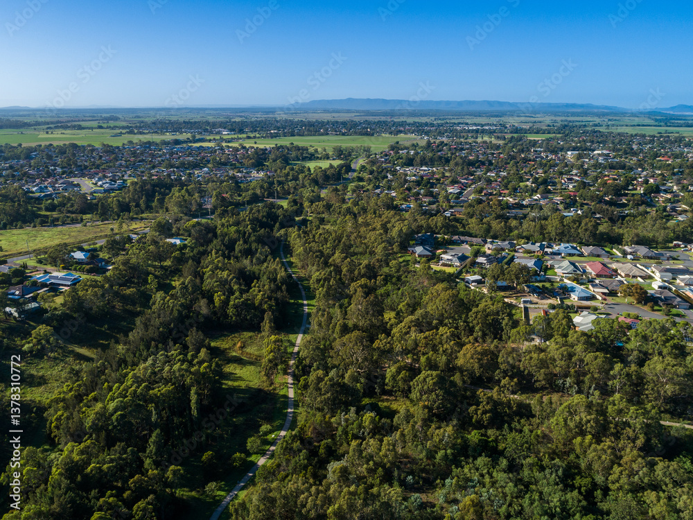 Footpath passing through parkland and nature reserve green strip in town suburb Footpath passing through parkland and nature reserve green strip in town suburb