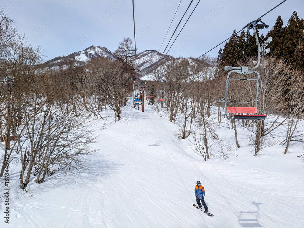 Snowboarder on a gentle ski slope at Hakuba in Nagano, Japan
