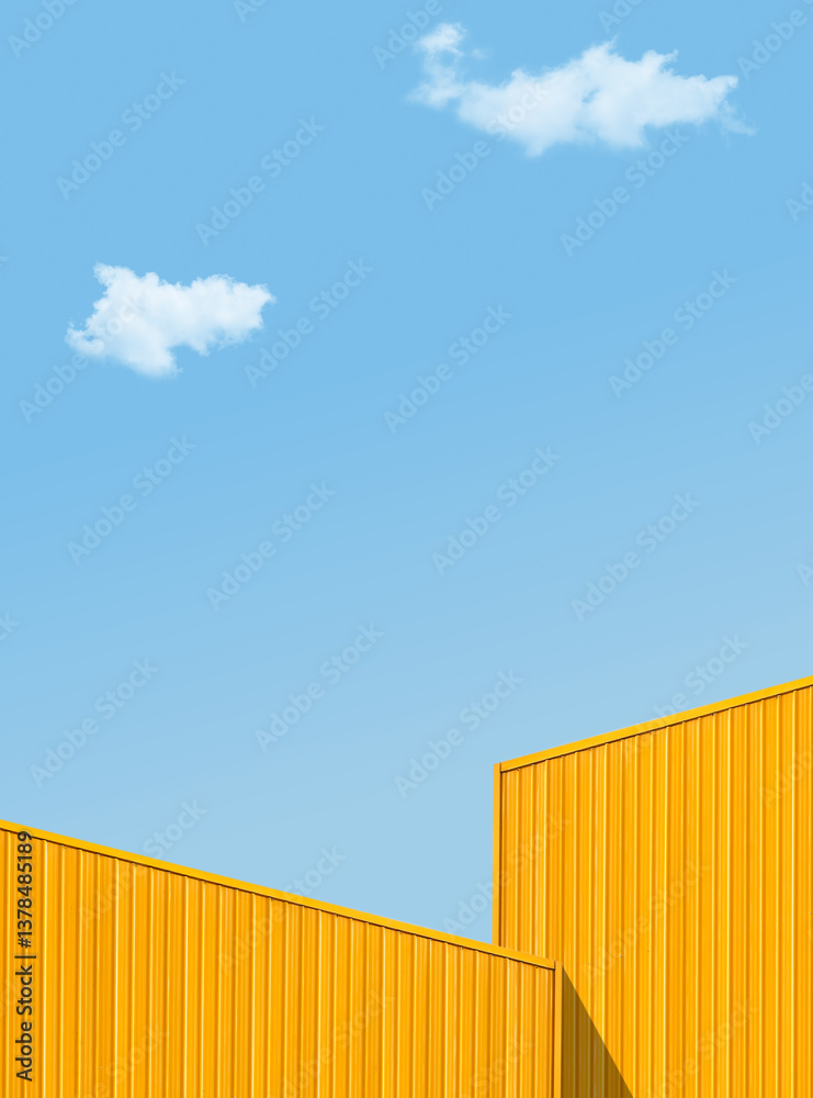 Fototapeta premium Roof facade yellow metal sheet building against blue sky clouds vertical on day well space for text presentation Backgrounds