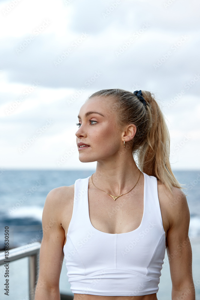 Young woman practising yoga by ocean Young woman practising yoga by ocean