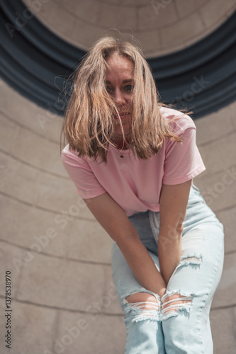 Joyful Young Woman Leaning Against Stone Wall